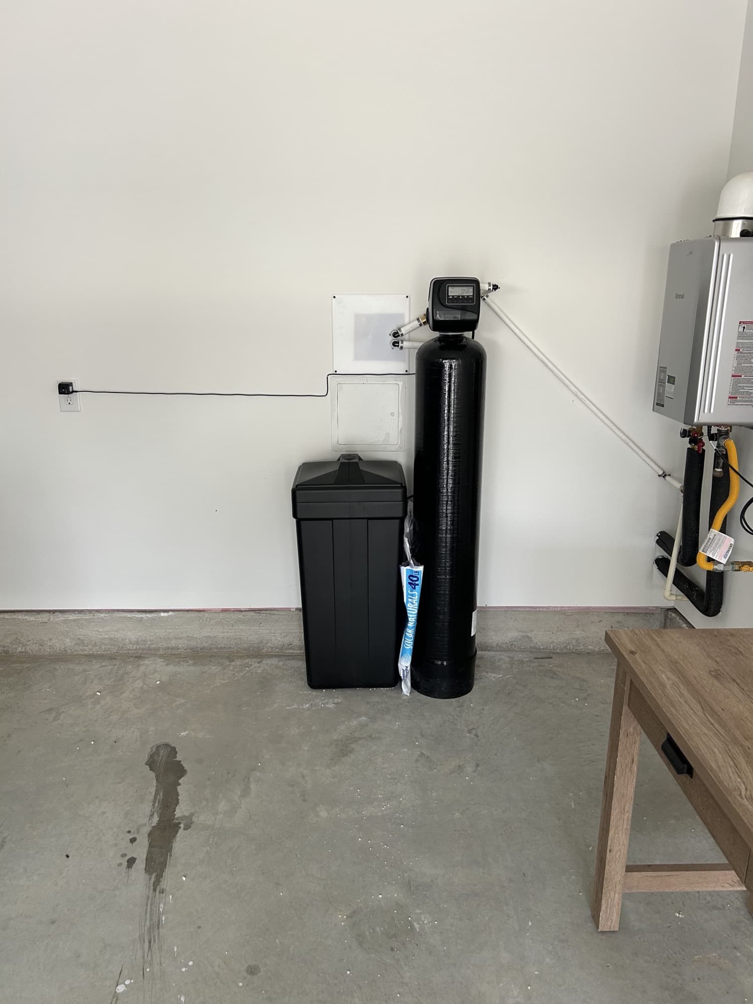 Water softener with brine tank installed in a clean garage corner