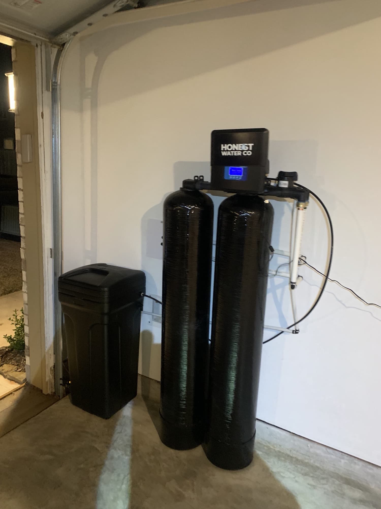 Honest Water Co twin tanks installed just inside a garage door