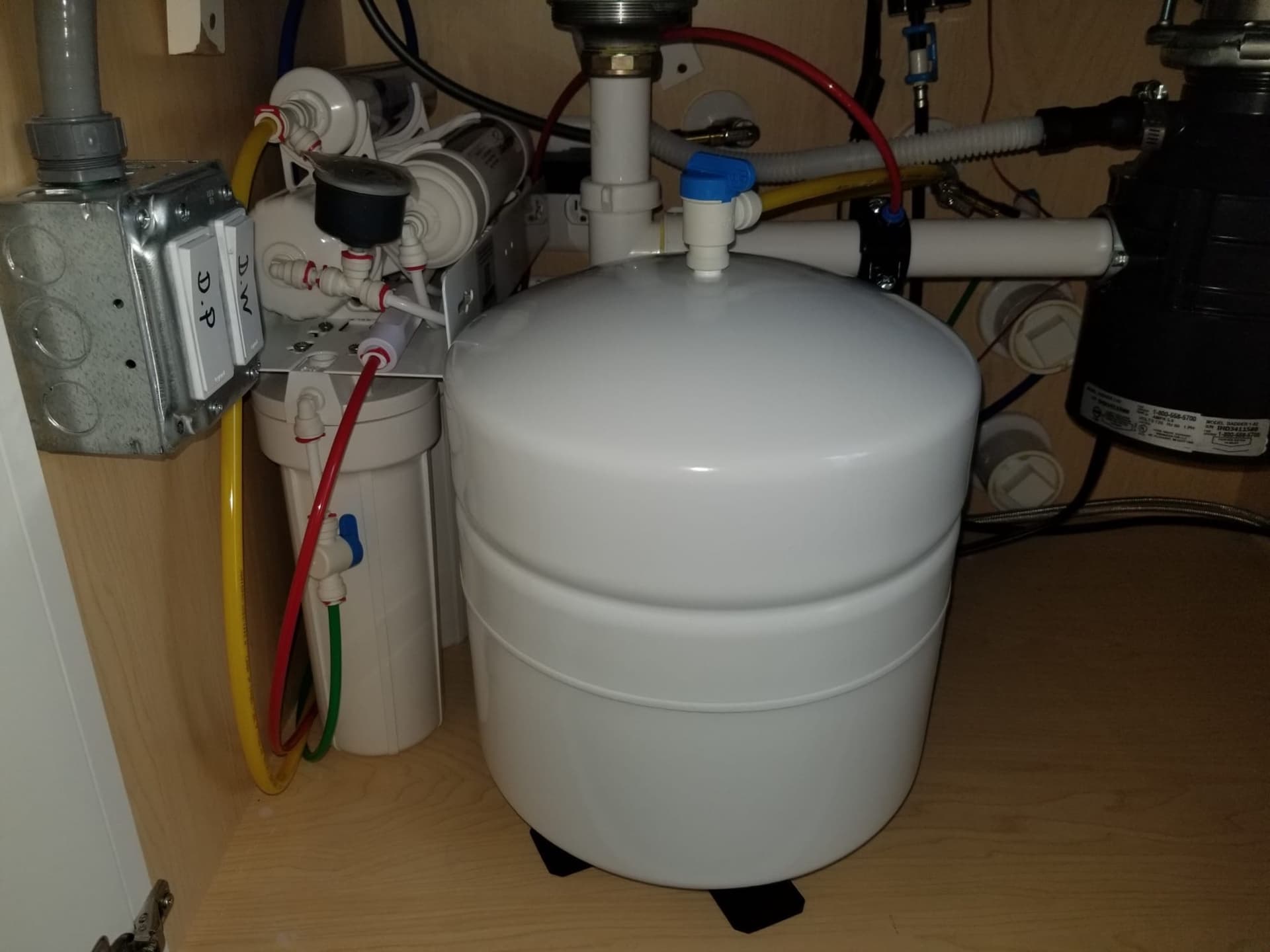 A tank reverse osmosis system installed under a customer kitchen sink